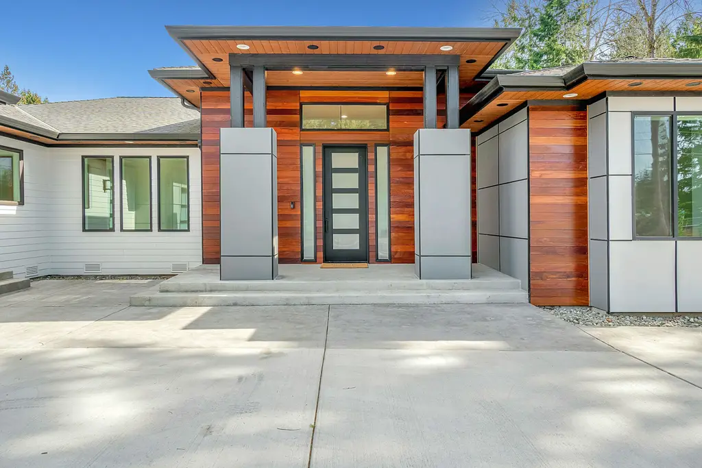 Fachada de una casa nueva con acabados de madera y acceso principal